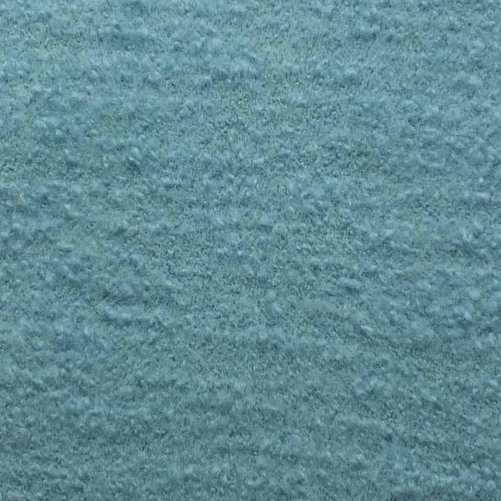 Close-up of muted blue-teal bouclé with a softly mottled, nubby texture