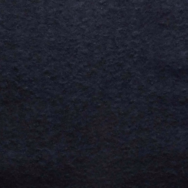 Deep navy boucle swatch showing a dense, shadowed nubby weave