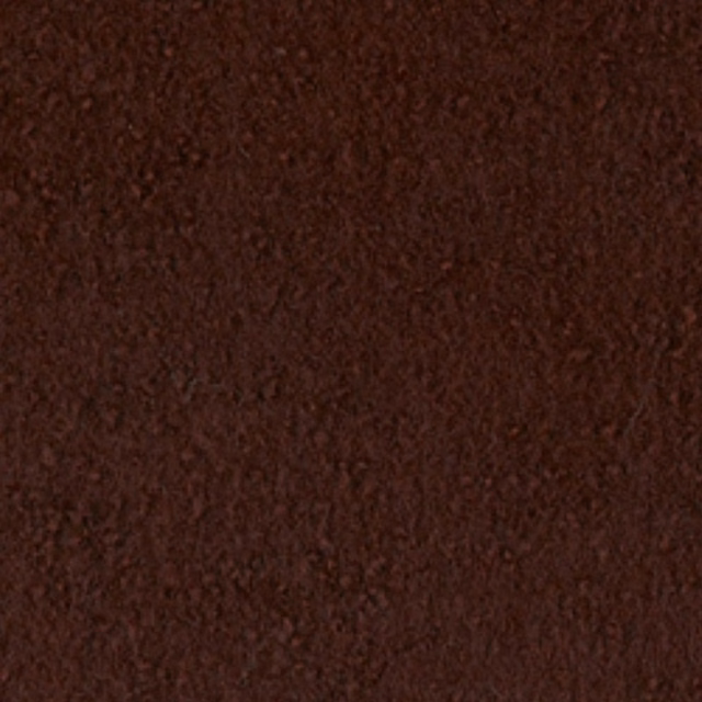 Close-up of dark oxblood boucle with dense, irregular nubby texture