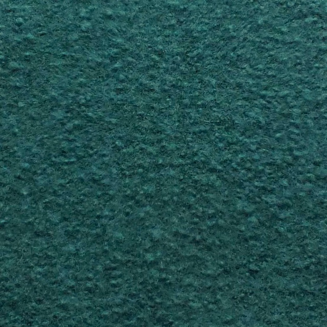 Deep pine-green boucle with a dense, softly mottled nubby texture