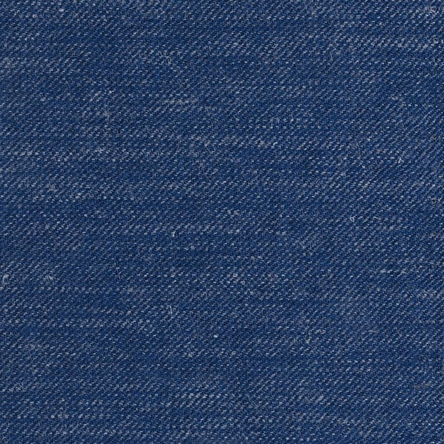 Close view of deep navy blue fabric with fine diagonal weave and lighter flecks