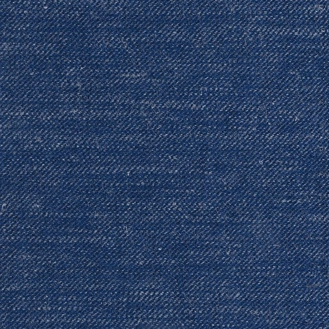 Close view of deep navy blue fabric with fine diagonal weave and lighter flecks