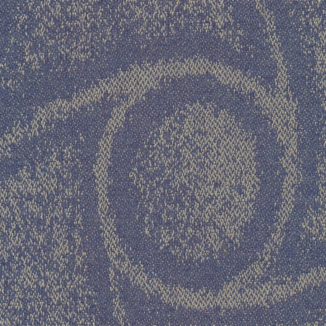 Muted denim-blue woven fabric with pale flecks and irregular concentric organic rings