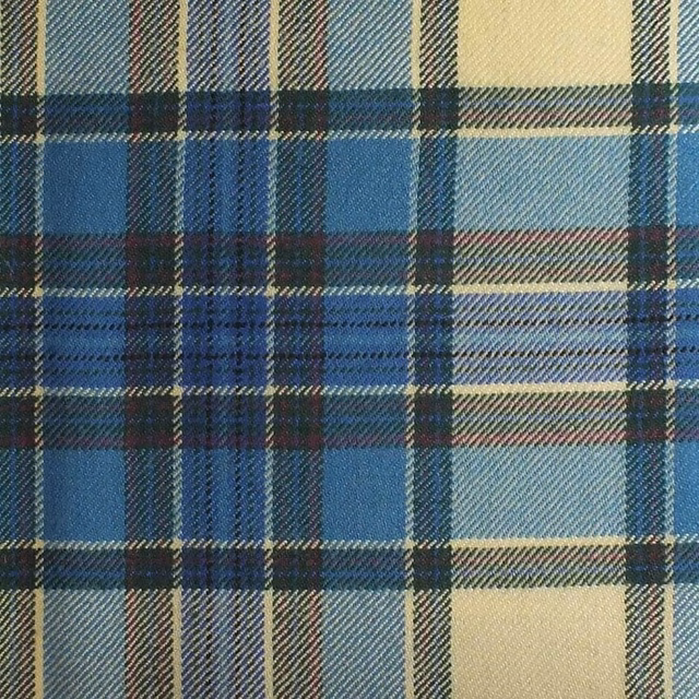 Turquoise and navy plaid fabric with cream blocks and a textured woven surface