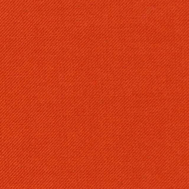 Close-up of warm brick-red fabric with a fine, even diagonal twill weave