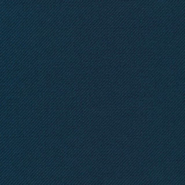 Close-up of dark petrol-blue twill with fine diagonal ridges and teal depth