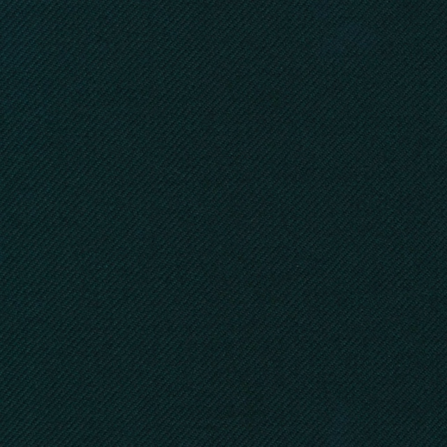 Close-up of deep pine-green fabric with a fine diagonal twill weave