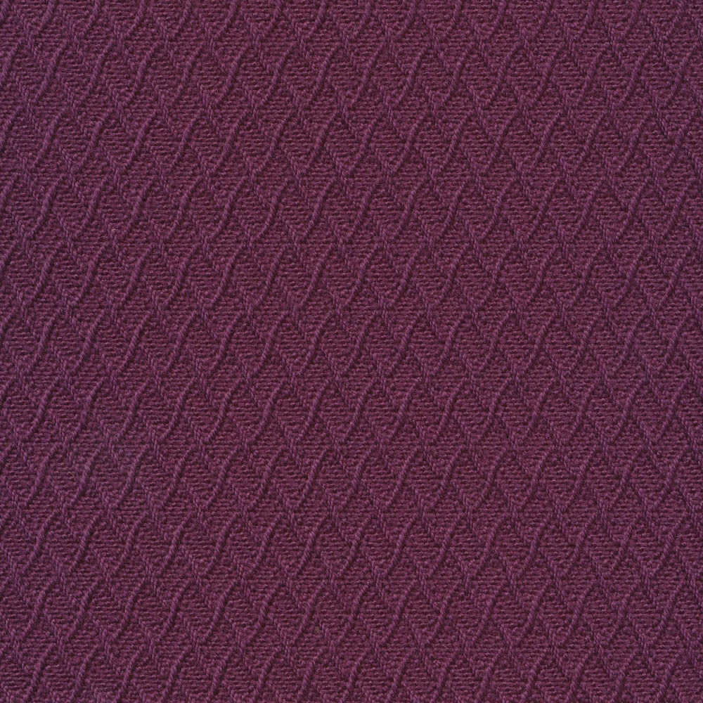 Close-up of deep plum-purple woven fabric with repeating raised chevron texture