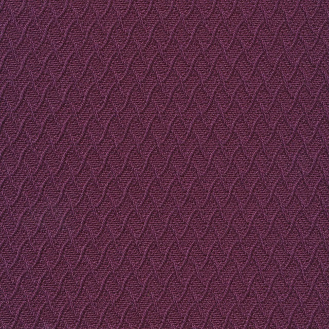 Close-up of deep plum-purple woven fabric with repeating raised chevron texture