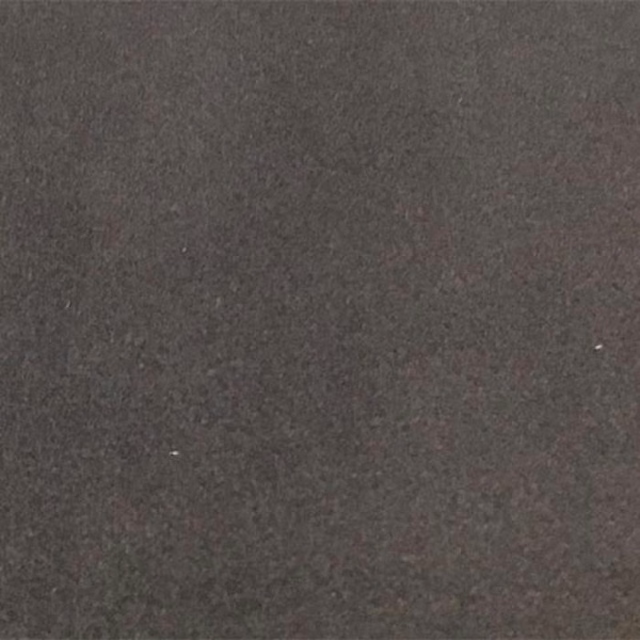 Close-up of a deep battleship grey plain upholstery fabric with a dense matte texture