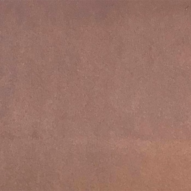 Close-up of a dusty lilac-pink plain fabric with a soft matte finish