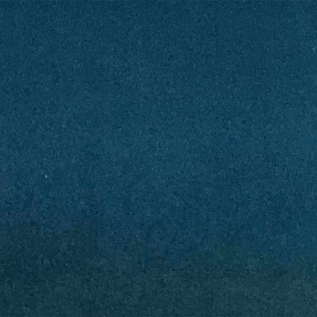 Deep teal plain fabric swatch with a soft, velvety texture