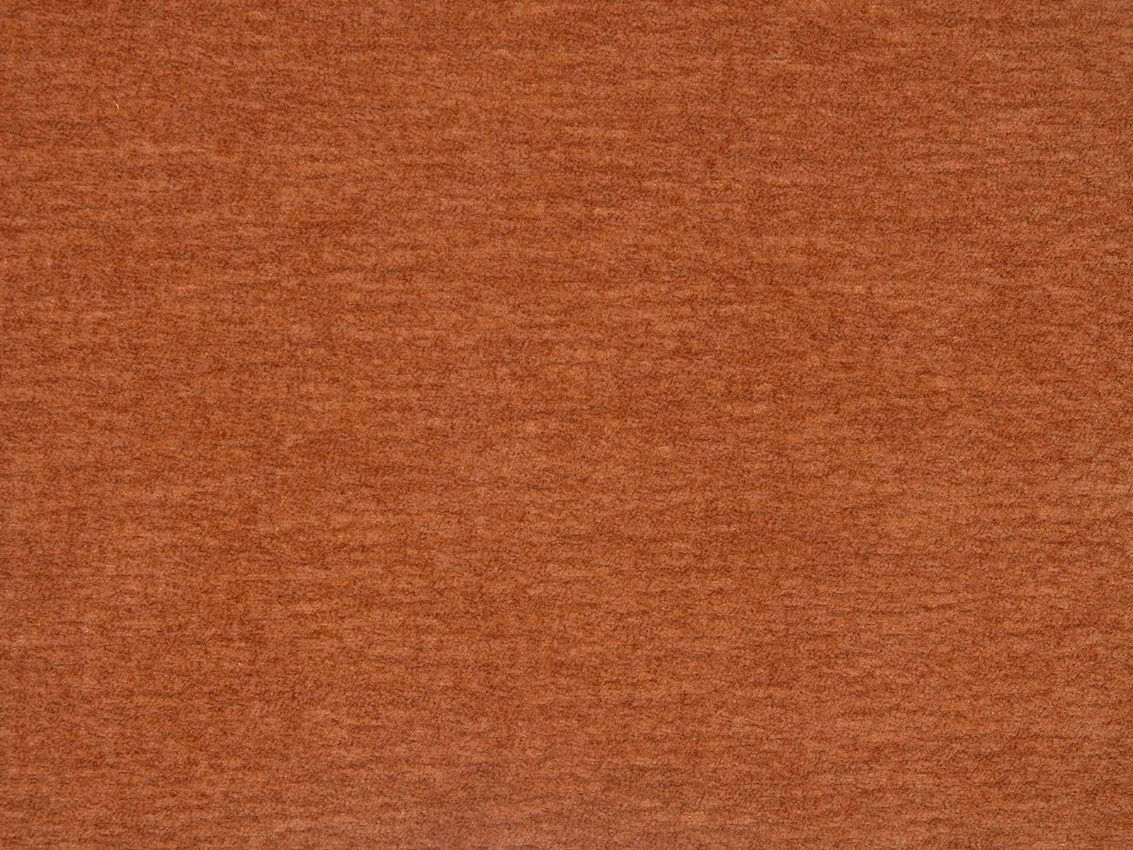 Close-up of a warm copper terracotta plain fabric with soft brushed texture