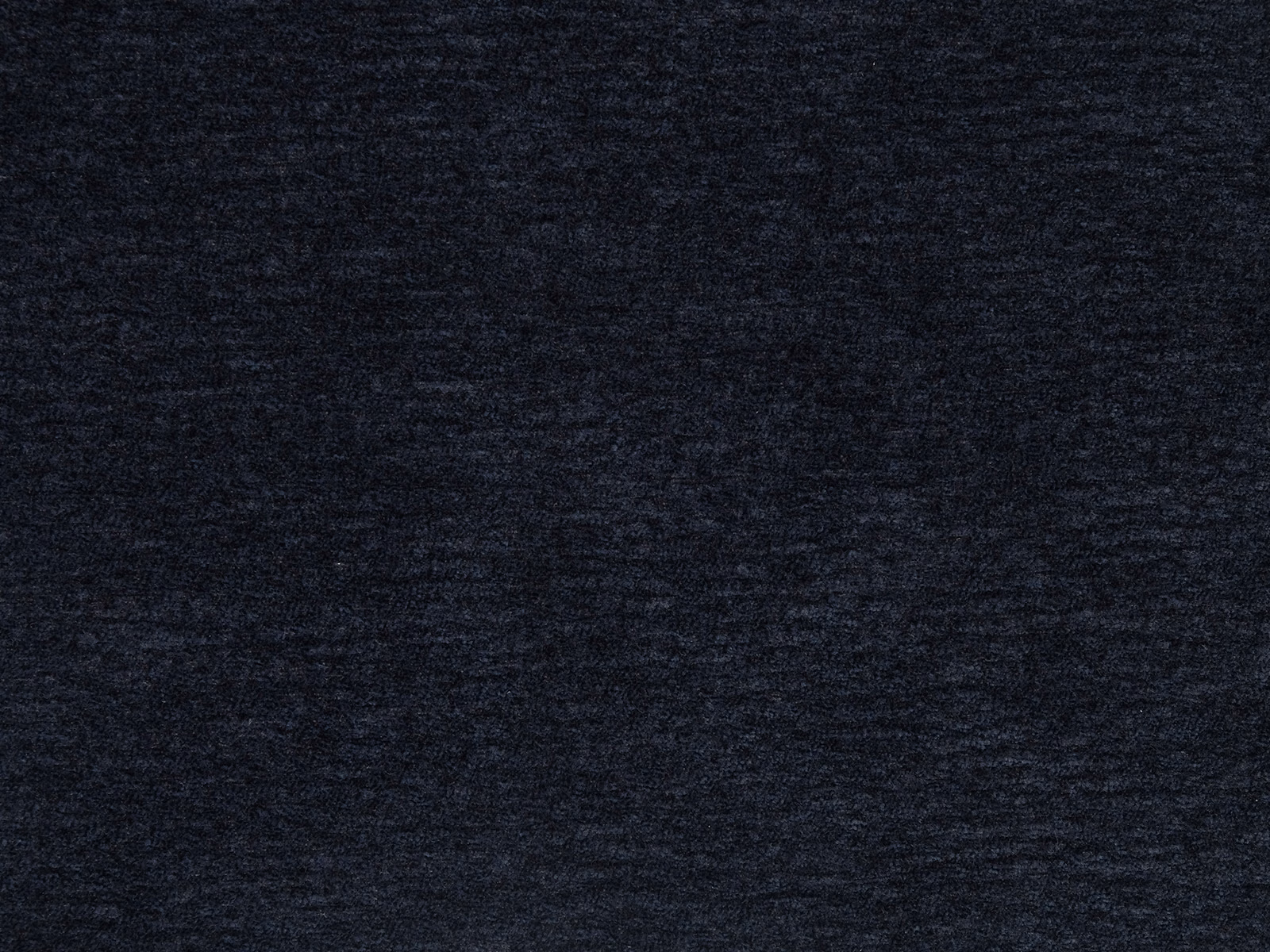 Close-up of deep indigo blue plain fabric with a soft mottled weave