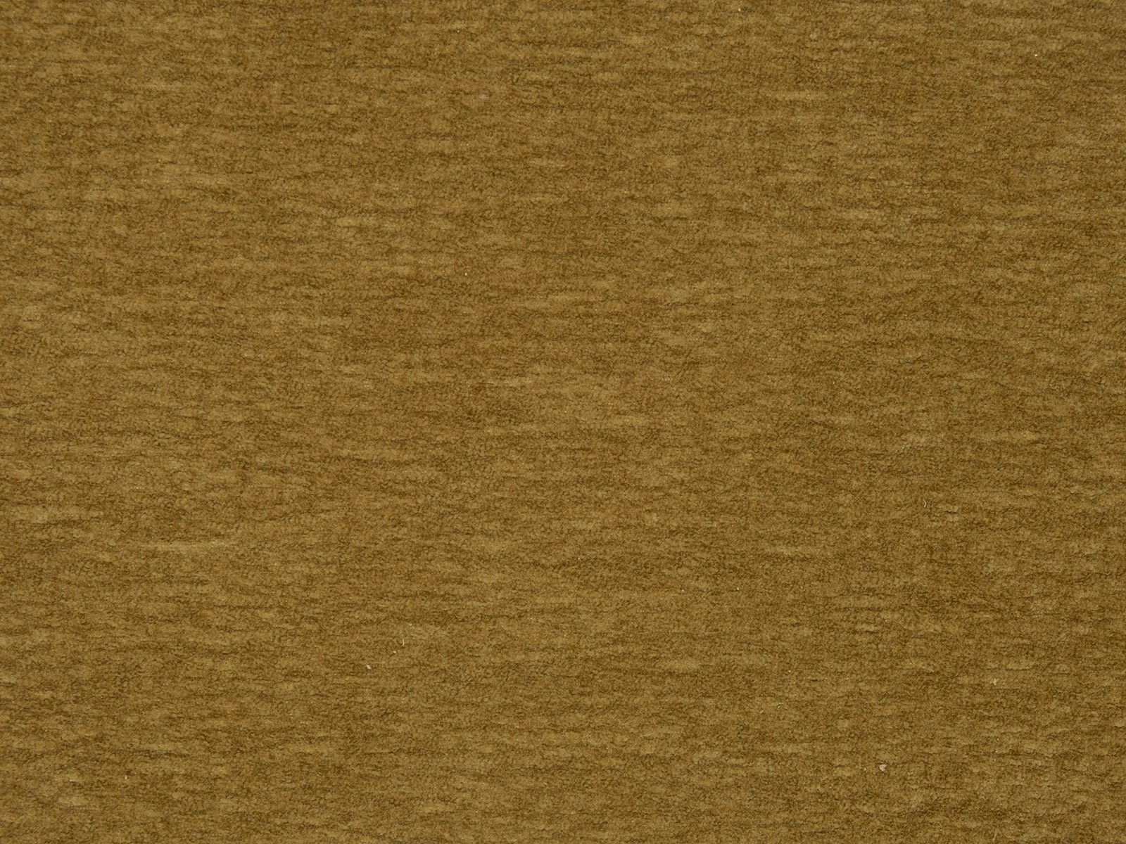 Close-up of muted lemongrass gold plain fabric with fine mottled texture