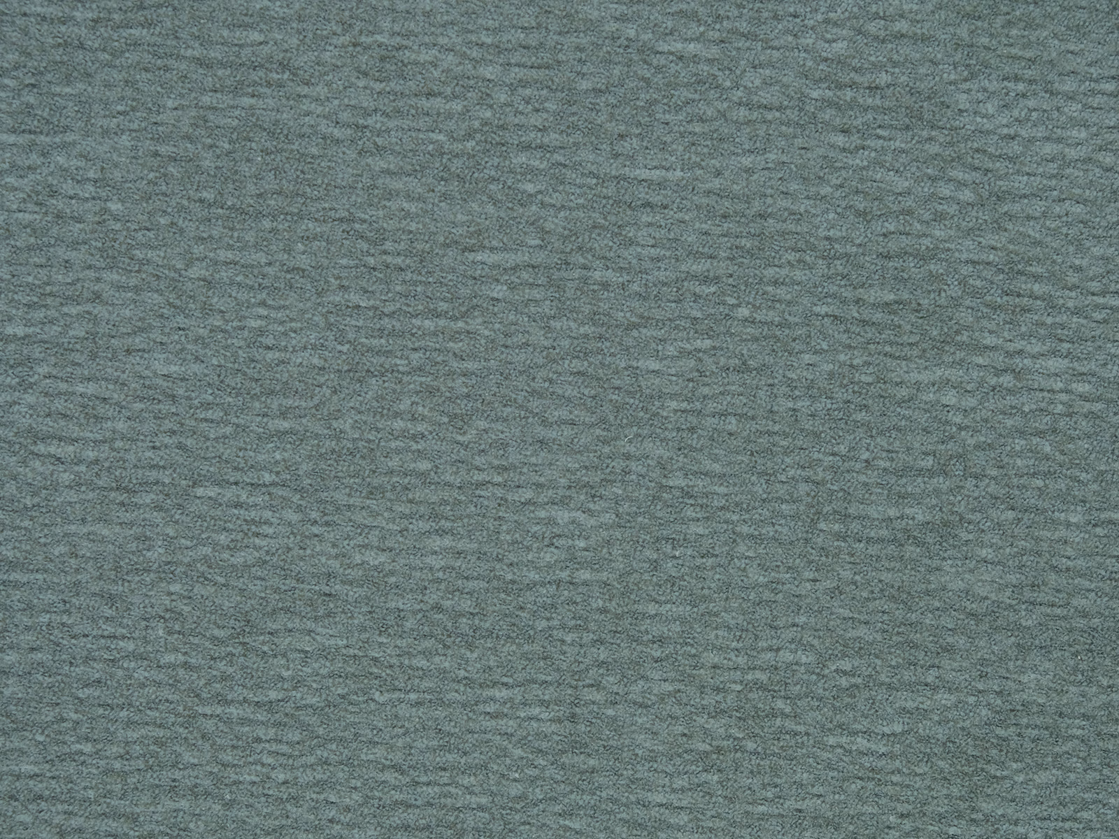 Close-up of muted sage green plain woven fabric with fine horizontal texture
