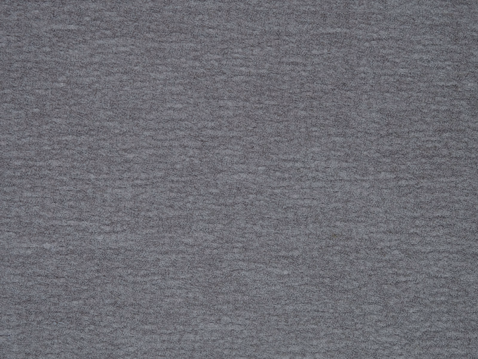 Close-up of a cool steel grey plain fabric with a softly mottled texture