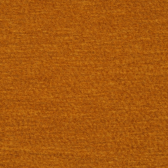 Close-up of a rich turmeric-gold plain fabric with a softly mottled, brushed texture