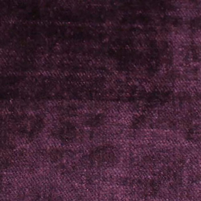 Close-up of deep aubergine-purple plain woven fabric with a soft textured finish