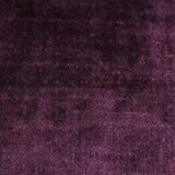 Close-up of deep aubergine-purple plain woven fabric with a soft textured finish