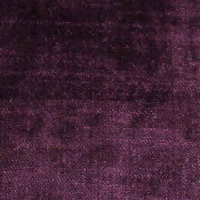 Close-up of deep aubergine-purple plain woven fabric with a soft textured finish