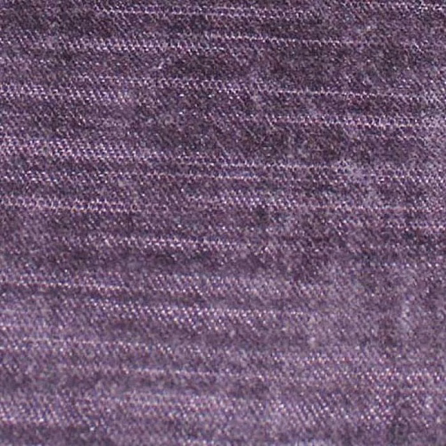 Close-up of plum-purple woven plain fabric with subtle slubs and soft sheen