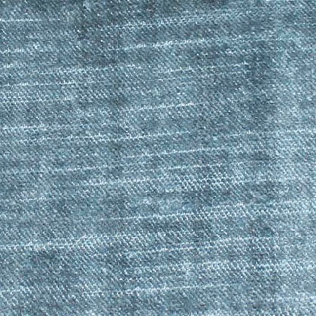 Close-up of cool slate blue plain-woven fabric with subtle horizontal texture
