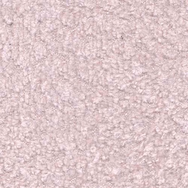 Close-up of a soft powder pink textured plain fabric with a nubby surface