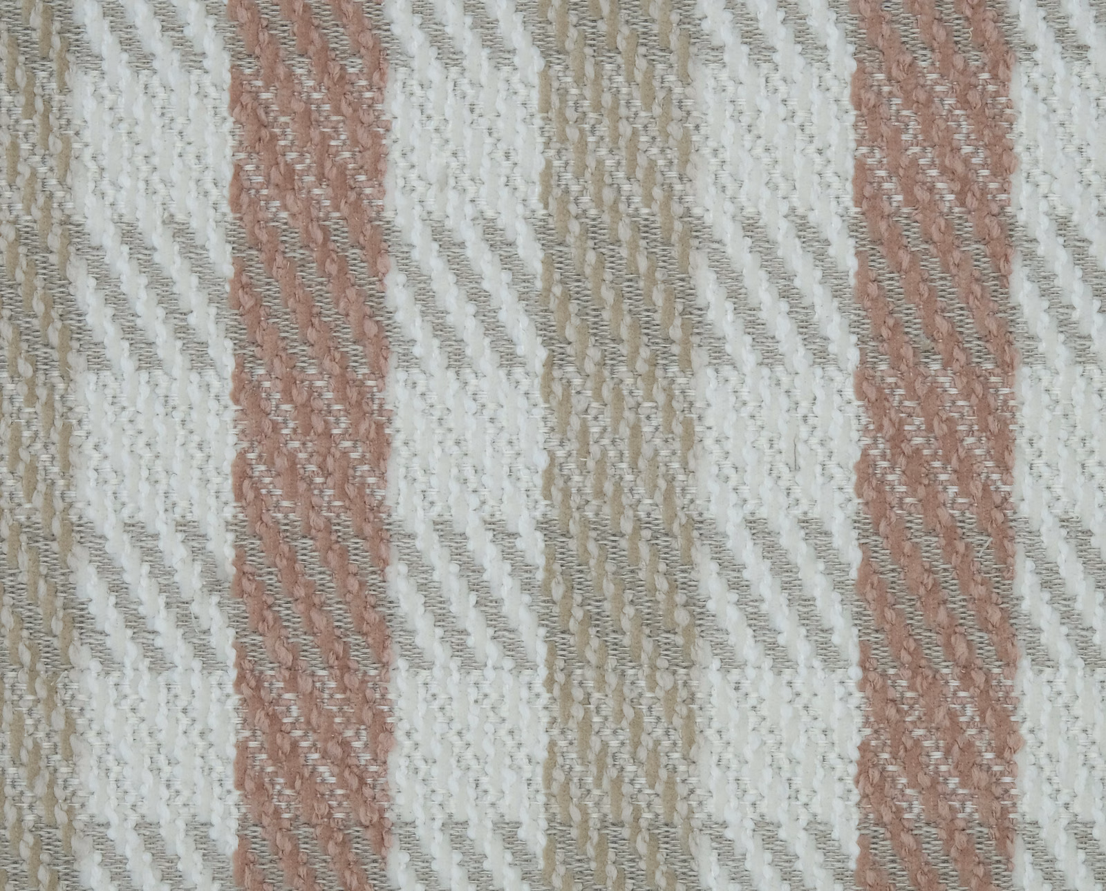 Close-up of blush pink and ivory striped woven fabric with textured slub