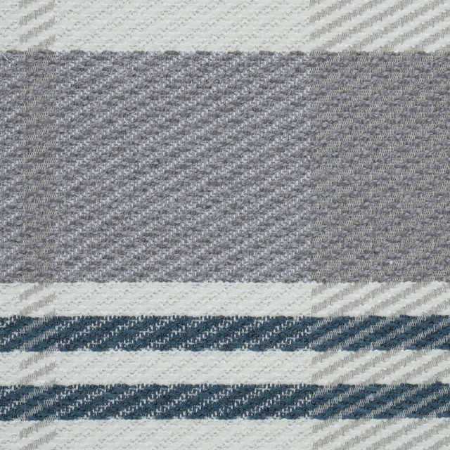 Close-up of a large petrol blue and ivory checked woven fabric with grey accents