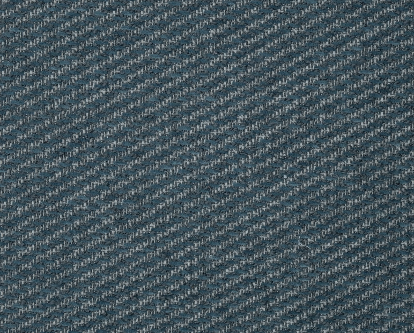 Close-up of a petrol blue woven fabric with diagonal textured flecks