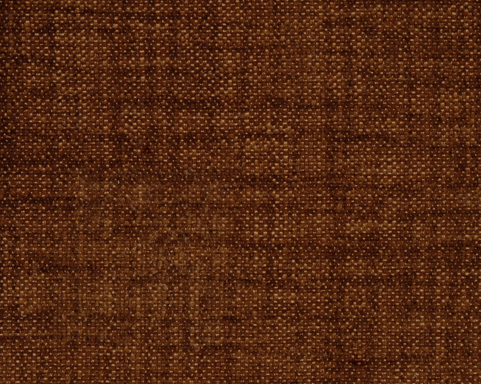 Close-up of warm cinnamon-brown plain weave fabric with subtle flecked texture