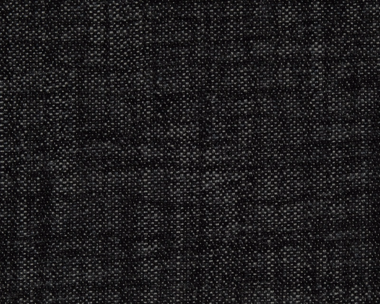 Close-up of a charcoal black textured plain weave with fine speckled highlights