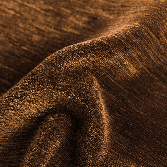 Close-up of a deep cinnamon-brown plain fabric with a subtly lustrous woven texture