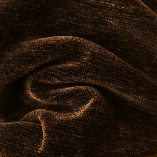 Dark cocoa brown textured fabric with soft bronze highlights in folded drape