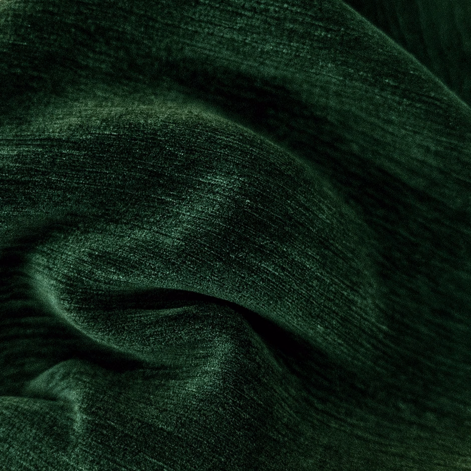 Deep forest green plain fabric with a soft, velvety sheen and dark folds