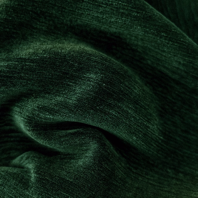 Deep forest green plain fabric with a soft, velvety sheen and dark folds
