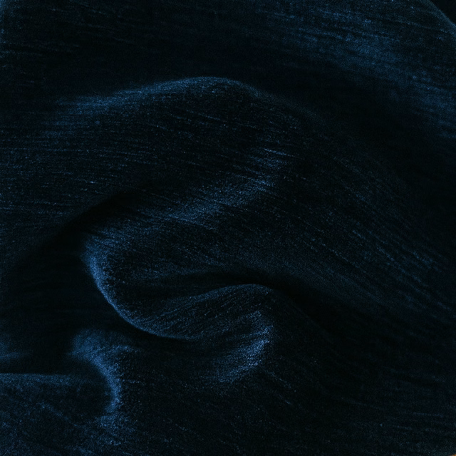 Close-up of dark navy plain fabric with a soft, lustrous sheen
