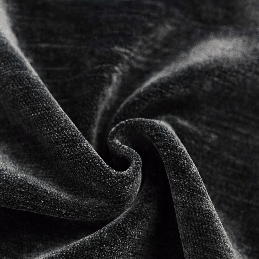 Close-up of a charcoal-black plain woven fabric with soft folded texture