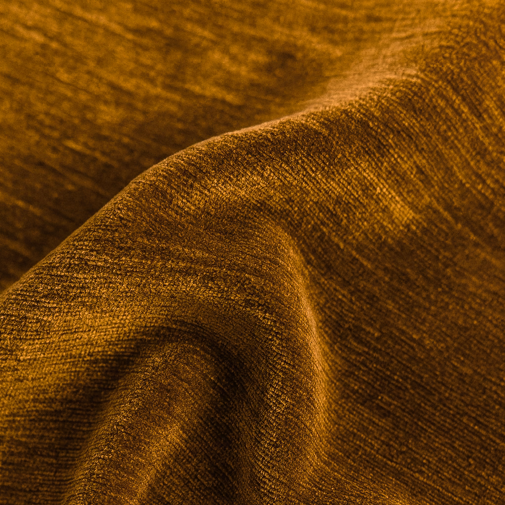 Burnished ochre gold plain fabric with a soft, velvet-like sheen and rich folds