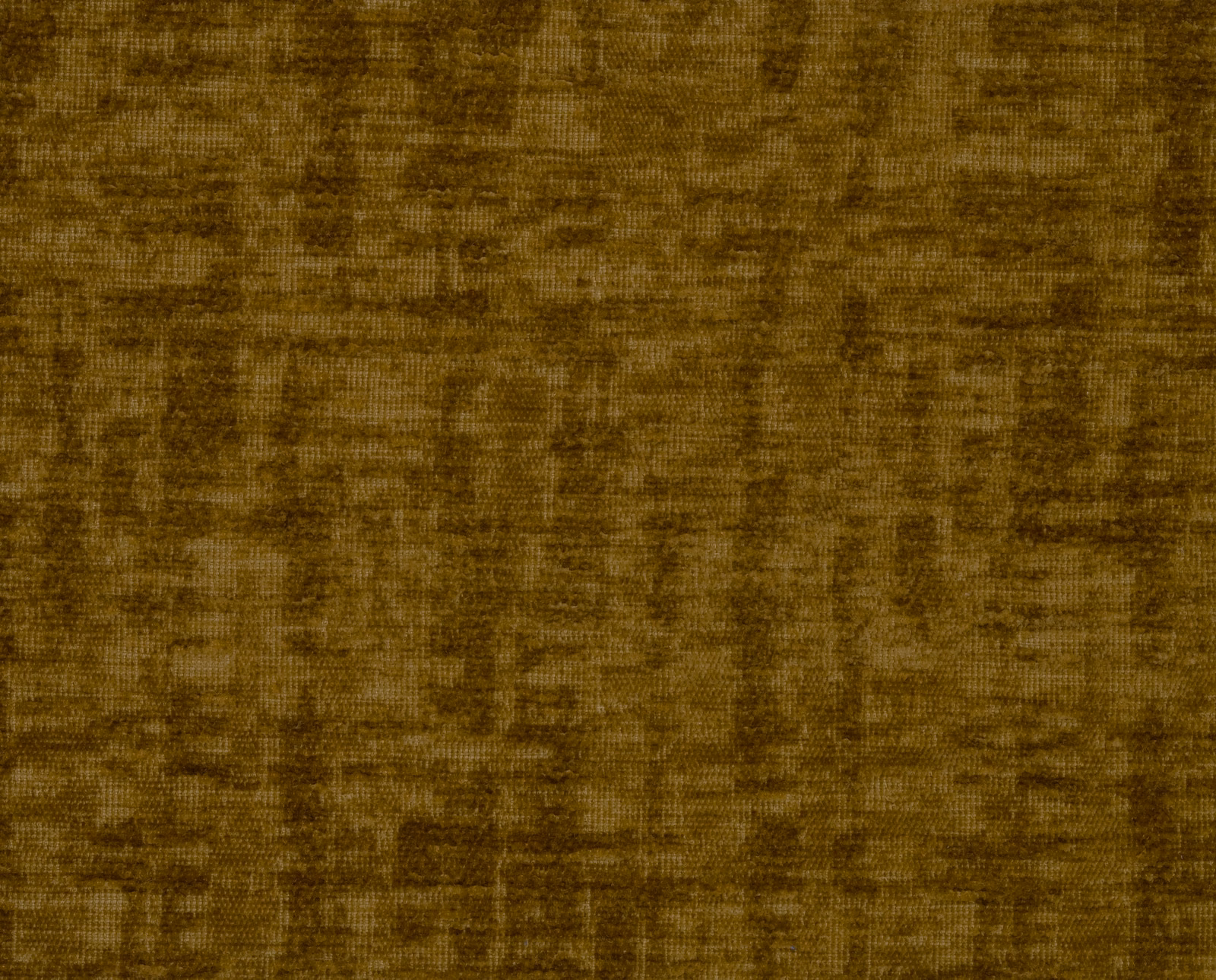 Close-up of a warm honey-gold plain fabric with mottled brown shading