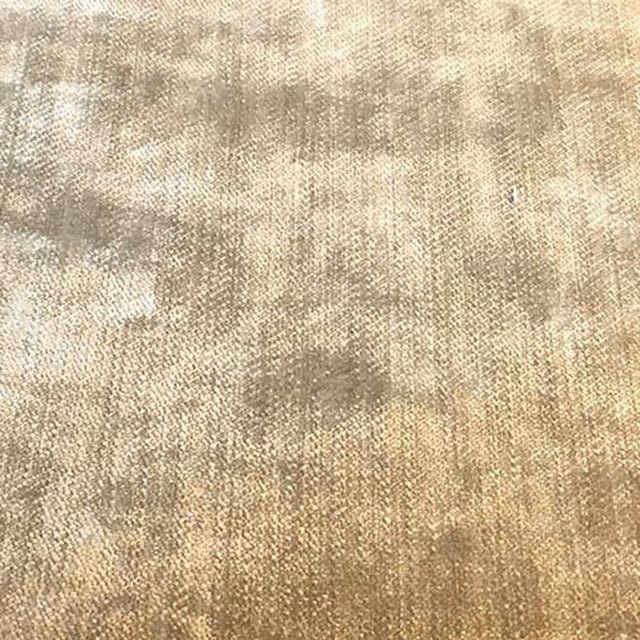 Warm mottled calico-beige upholstery fabric with a subtle woven texture