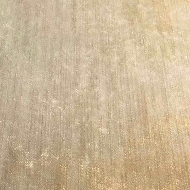 Close-up of a warm camel-beige plain fabric with subtle vertical striations and soft sheen