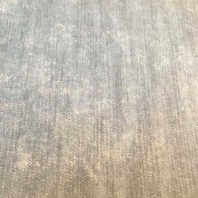 Soft cloud-grey plain fabric with a subtle pearly, speckled texture
