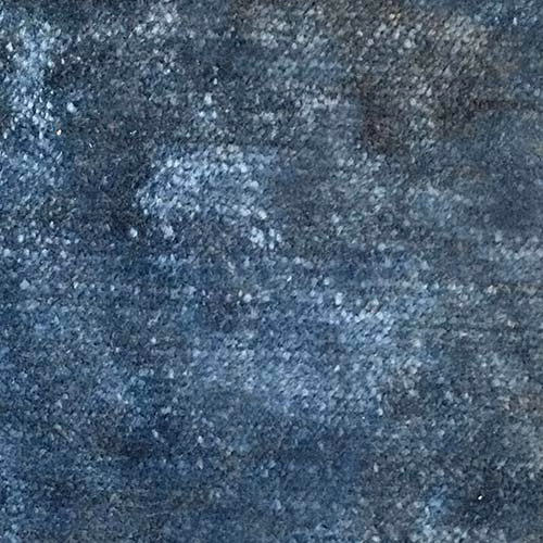 Mottled denim-blue plain fabric swatch with grey flecked texture