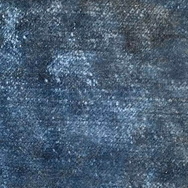 Mottled denim-blue plain fabric swatch with grey flecked texture