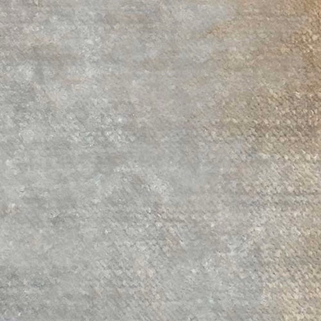 Soft fossil-grey plain fabric with a fine mottled texture and subtle stone warmth