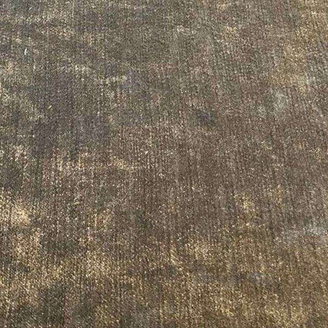 Close-up of warm olive-grey woven plain fabric with subtle speckled sheen