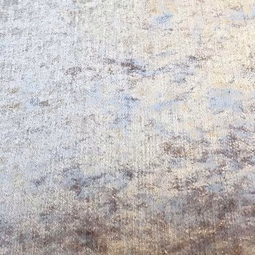 Close-up of a heathered taupe-grey plain fabric with misty cream and lilac-brown shading