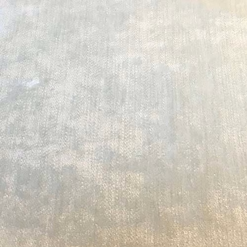 Pale ivory plain fabric swatch with a softly mottled, lightly lustrous texture